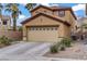 Charming two-story home featuring a two-car garage and desert landscaping at 651 Penshaw Bridge Ave, Las Vegas, NV 89178