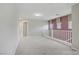 Bright hallway with neutral paint, plush carpet and modern railing at 651 Penshaw Bridge Ave, Las Vegas, NV 89178