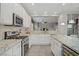 A bright and modern kitchen with a view into the living room at 651 Penshaw Bridge Ave, Las Vegas, NV 89178