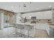 Modern kitchen with island, stainless steel appliances, and sliding door access to backyard at 651 Penshaw Bridge Ave, Las Vegas, NV 89178