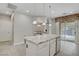 Stylish kitchen island with granite countertop, seating, and stainless steel appliances at 651 Penshaw Bridge Ave, Las Vegas, NV 89178