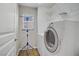 Functional laundry area with modern washer and dryer appliances and storage shelves at 651 Penshaw Bridge Ave, Las Vegas, NV 89178