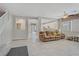 Open-concept living room with tile flooring, cozy seating, and stairway access at 651 Penshaw Bridge Ave, Las Vegas, NV 89178