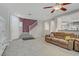 Open living area with tile floors, comfortable sofa, and a staircase to the upper level at 651 Penshaw Bridge Ave, Las Vegas, NV 89178