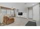 Open-concept living room with a large TV entertainment center and tile floors at 651 Penshaw Bridge Ave, Las Vegas, NV 89178