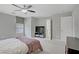Main bedroom featuring carpet, ceiling fan, window coverings, and an ensuite bathroom at 651 Penshaw Bridge Ave, Las Vegas, NV 89178