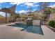 Backyard swimming pool with a water feature and mature landscaping at 651 Penshaw Bridge Ave, Las Vegas, NV 89178