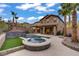 Resort-style backyard with custom spa, modern waterfall feature, lush greenery, and spacious patio for endless entertainment at 651 Penshaw Bridge Ave, Las Vegas, NV 89178