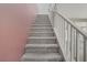 Carpeted stairway with white handrail leads to the upper level of the house at 651 Penshaw Bridge Ave, Las Vegas, NV 89178