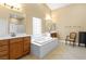 Bathroom with dual vanities, a soaking tub, and a separate shower at 6917 Puetollano Dr, North Las Vegas, NV 89084