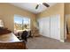 Well-lit bedroom provides bright windows, ample workspace, and neutral paint for comfortable living at 6917 Puetollano Dr, North Las Vegas, NV 89084