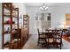 Bright dining area with hardwood floors, custom shelving, and a view of the open living space at 6917 Puetollano Dr, North Las Vegas, NV 89084