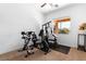Bright exercise room features carpet flooring, gym equipment, and lots of natural light at 6917 Puetollano Dr, North Las Vegas, NV 89084