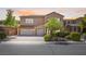 Charming two-story home featuring a three-car garage and beautifully landscaped front yard at 6917 Puetollano Dr, North Las Vegas, NV 89084