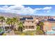 An exterior elevation featuring a swimming pool, solar panels, and desert landscaping at 6917 Puetollano Dr, North Las Vegas, NV 89084
