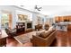 Bright living room features hardwood floors, stone fireplace and large windows at 6917 Puetollano Dr, North Las Vegas, NV 89084