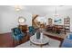 Combined living and dining area featuring hardwood floors, staircase, and tastefully coordinated furnishings at 6917 Puetollano Dr, North Las Vegas, NV 89084