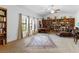 Spacious home office with built-in bookshelves, a large desk, and lots of natural light at 6917 Puetollano Dr, North Las Vegas, NV 89084