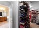 Well-organized walk-in closet with shelves and hanging space, bathroom in view at 6917 Puetollano Dr, North Las Vegas, NV 89084