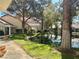 Backyard view featuring a tranquil pond, mature trees, and manicured landscaping for a peaceful outdoor setting at 6987 Emerald Springs Ln, Las Vegas, NV 89113