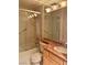 This bathroom features a tub, shower, tile surround, and a vanity with marble countertop at 6987 Emerald Springs Ln, Las Vegas, NV 89113