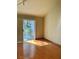 Bedroom with sliding glass door leading to patio with hardwood floors at 6987 Emerald Springs Ln, Las Vegas, NV 89113