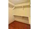 Walk-in closet features hardwood floors and shelving for organization and storage at 6987 Emerald Springs Ln, Las Vegas, NV 89113