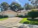 Charming single-story home with a well-maintained lawn, mature trees, and a spacious two-car garage at 6987 Emerald Springs Ln, Las Vegas, NV 89113