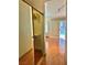 Hallway with closet leading into room with hardwood floors and plantation shutters at 6987 Emerald Springs Ln, Las Vegas, NV 89113