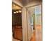 Hallway view of bathroom and bedroom with hardwood floors and neutral walls at 6987 Emerald Springs Ln, Las Vegas, NV 89113