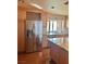 Modern kitchen with stainless steel appliances, built-in wine rack, and granite countertops at 6987 Emerald Springs Ln, Las Vegas, NV 89113