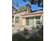 Charming patio featuring a tile roof, textured walls, and delightful potted plants for relaxed outdoor living at 6987 Emerald Springs Ln, Las Vegas, NV 89113