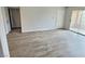 Spacious living room featuring wood-look flooring and access to the balcony at 7885 W Flamingo Rd # 2153, Las Vegas, NV 89147