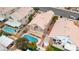 Aerial shot of a private backyard featuring a sparkling pool, covered patio, and lush landscaping for outdoor living at 7905 Coral Point Ave, Las Vegas, NV 89128