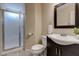 Well-lit bathroom showcases a glass-door shower, vanity with sink, and neutral wall colors at 7905 Coral Point Ave, Las Vegas, NV 89128