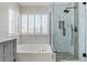 Bathroom showcasing a soaking tub and a glass-enclosed shower with marble-look tile at 7905 Coral Point Ave, Las Vegas, NV 89128