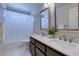 Bright bathroom features a double sink vanity, framed mirrors, and a shower-tub combination at 7905 Coral Point Ave, Las Vegas, NV 89128