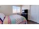 Cozy bedroom with a window, closet, dresser, and stylish bedding creating a comfortable space at 7905 Coral Point Ave, Las Vegas, NV 89128