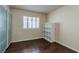 Simple bedroom featuring a window with shutters, closet with sliding doors, and a shelving unit at 7905 Coral Point Ave, Las Vegas, NV 89128