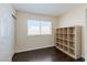 Neutral bedroom with wood floors, a closet, window, and shelving unit for organization and storage at 7905 Coral Point Ave, Las Vegas, NV 89128
