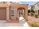Inviting front entrance with an arched entryway and a well-maintained walkway at 7905 Coral Point Ave, Las Vegas, NV 89128