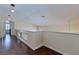 Upstairs hallway with dark wood flooring and white walls at 7905 Coral Point Ave, Las Vegas, NV 89128