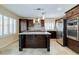 Modern kitchen with island, stainless steel appliances, and stylish backsplash at 7905 Coral Point Ave, Las Vegas, NV 89128
