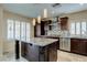Features a kitchen island with a granite countertop and three pendant lights at 7905 Coral Point Ave, Las Vegas, NV 89128