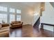Spacious living room featuring hardwood floors and large windows with shutter blinds at 7905 Coral Point Ave, Las Vegas, NV 89128