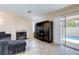 Comfortable living area with fireplace, TV cabinet, and access to the outdoor pool at 7905 Coral Point Ave, Las Vegas, NV 89128