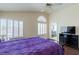A primary bedroom with hardwood floors, vaulted ceilings, window shutters, and an en-suite bathroom at 7905 Coral Point Ave, Las Vegas, NV 89128