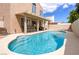 Backyard pool with a covered patio and lounge furniture, ideal for relaxation and entertaining at 7905 Coral Point Ave, Las Vegas, NV 89128