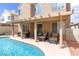 Inviting backyard features a pool, covered patio, and outdoor seating, great for entertaining at 7905 Coral Point Ave, Las Vegas, NV 89128