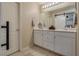 Bright bathroom with white double vanity, modern lighting, and stylish sliding barn door at 7919 Mineral Peak St, Las Vegas, NV 89166